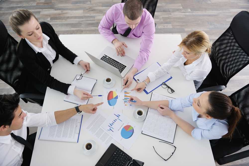 Group of young business people sitting